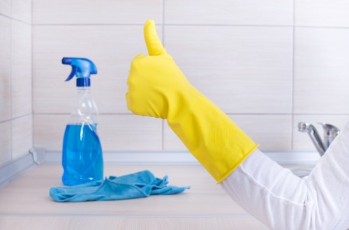 Staff member wearing PPE while operating carpet cleaning equipment